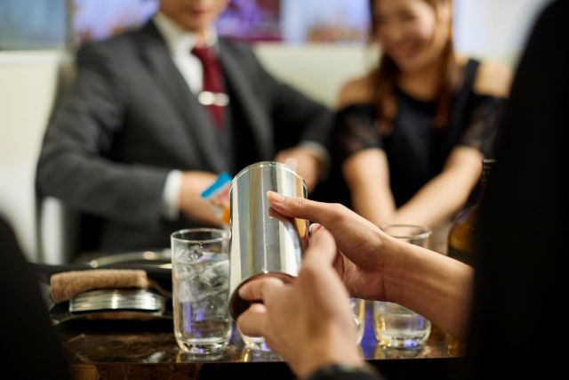 お酒を注ぐ女性の手